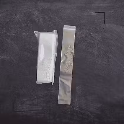a pair of zip bags on top of a blackboard