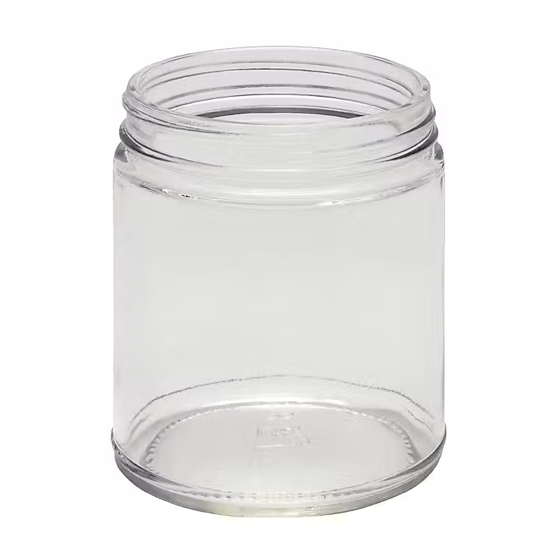 un bocal transparent avec un couvercle sur fond blanc