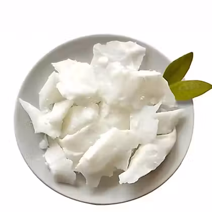 coconut flakes in a white plate on a white background