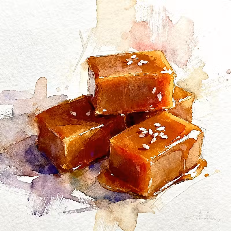 3 morceaux de cubes bruns de caramel, l'un sur l'autre