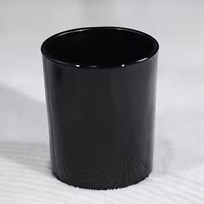 A cup sitting on top of a white surface